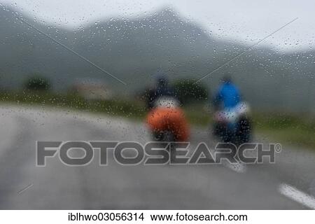 "Tourists cycling on the European route E10, rain, blurred vision through a car window, Falkstad, Lofoten, Nordland, Northern Norway, Norway, Europe" View Large Photo Image Picture - "Tourists cycling on the European route E10, rain, blurred vision through a car window, Falkstad, Lofoten, Nordland, Northern Norway, Norway, Europe". Fotosearch