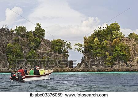 "Tourists in a boat, Raja Ampat, West Papua, Indonesia, Asia" View Large Photo Image Stock Photo - "Tourists in a boat, Raja Ampat, West Papua, Indonesia, Asia". Fotosearch