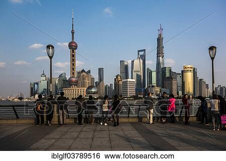 "Tourists in front of the Pudong skyline with Oriental Pearl Tower, Shanghai World Financial Center and Shanghai Tower, from the Bund, Shanghai, China, Asia" View Large Photo Image Stock Photograph - "Tourists in front of the Pudong skyline with Oriental Pearl Tower, Shanghai World Financial Center and Shanghai Tower, from the Bund, Shanghai, China, Asia". Fotosearch