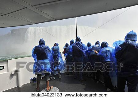 Stock Image - "Tourists in raincoats on the tour boat Maid of the Mist, Horseshoe Falls, Niagara Falls, Niagara Falls, Ontario Province, Canada, North America". Fotosearch