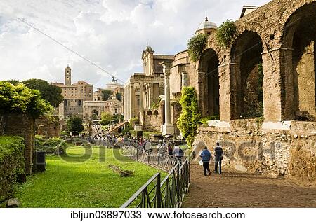Stock Image - "Tourists in Via Sacra, Maxentius Basilica, Romulus Temple, Temple of Antonius and Faustina, Arch of Septimius Servus, Capitol, Capitoline Museums, Monumento Nazionale a Vittorio Emanuele II, Roman Forum, Lazio, Rome, Italy, Europe". Fotosearch