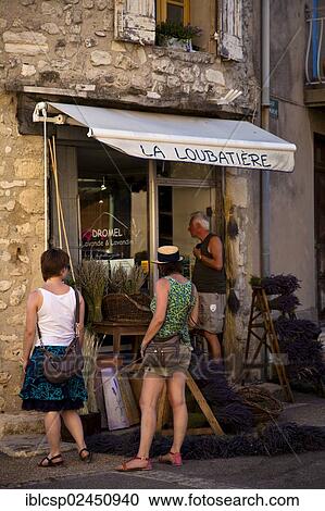 Stock Image - "Tourists looking at display of lavender shop, Sault, Vaucluse, Provence, France, Europe". Fotosearch