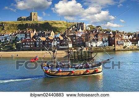 Stock Image - "Tourists on a pirate boat in Whitby harbour, North Yorkshire, England, United Kingdom, Europe". Fotosearch