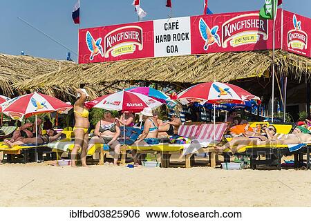 "Tourists on the beach in front of Cafe Hard Rock Goa, Calangute Beach, Calangute, Goa, India, Asia" View Large Photo Image Stock Photograph - "Tourists on the beach in front of Cafe Hard Rock Goa, Calangute Beach, Calangute, Goa, India, Asia". Fotosearch