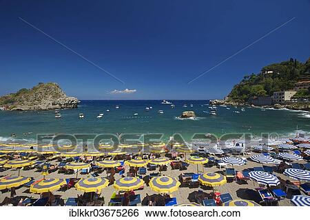 Stock Photograph - "Tourists on the beach, umbrellas and sun loungers, Bay of Mazzaro, Taormina, Province of Messina, Sicily, Italy, Europe". Fotosearch