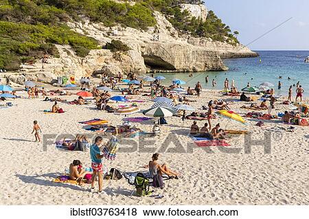 "Tourists on the sandy Cala Mitjana Beach, Minorca, Balearic Islands, Spain, Europe" View Large Photo Image Stock Photo - "Tourists on the sandy Cala Mitjana Beach, Minorca, Balearic Islands, Spain, Europe". Fotosearch