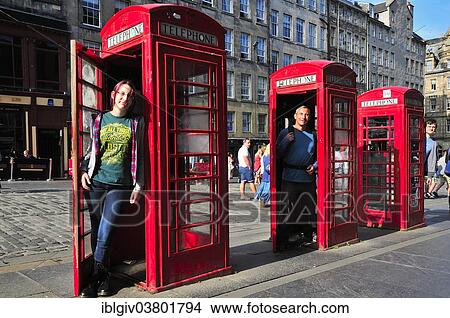 "Tourists posing in three typical telephone booth in the High Street, Edinburgh, Scotland, United Kingdom, Europe" View Large Photo Image Picture - "Tourists posing in three typical telephone booth in the High Street, Edinburgh, Scotland, United Kingdom, Europe". Fotosearch