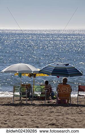 Stock Photography - "Tourists relaxing under sunshades on the beach, the sea at the back, Fuengirola, Costa del Sol, Andalusia, Spain, Europe, PublicGround, Europe". Fotosearch