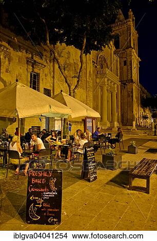 "Tourists sitting in an outdoor restaurant at St. John's Co-Cathedral, European Capital of Culture 2018, Valletta, Malta, Europe" View Large Photo Image Picture - "Tourists sitting in an outdoor restaurant at St. John's Co-Cathedral, European Capital of Culture 2018, Valletta, Malta, Europe". Fotosearch