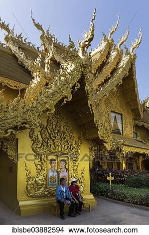 "Tourists sitting in front of the gilded toilet house at Wat Rong Khun, White Temple, by architect Chalermchai Kositpipat, Chiang Rai, Chiang Rai Province, Northern Thailand, Thailand, Asia" View Large Photo Image Picture - "Tourists sitting in front of the gilded toilet house at Wat Rong Khun, White Temple, by architect Chalermchai Kositpipat, Chiang Rai, Chiang Rai Province, Northern Thailand, Thailand, Asia". Fotosearch