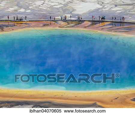 "Tourists standing on the edge of Grand Prismatic Spring, Yellowstone National Park, Wyoming, United States, North America" View Large Photo Image Stock Photography - "Tourists standing on the edge of Grand Prismatic Spring, Yellowstone National Park, Wyoming, United States, North America". Fotosearch