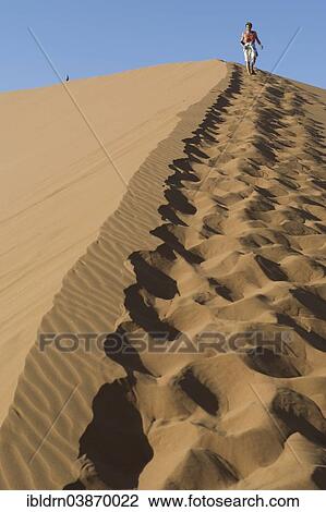 "Tourists walking in the sand of Dune 45, Tsauchab Valley, Sesriem, Hardap Region, Namibia, Africa" View Large Photo Image Stock Image - "Tourists walking in the sand of Dune 45, Tsauchab Valley, Sesriem, Hardap Region, Namibia, Africa". Fotosearch