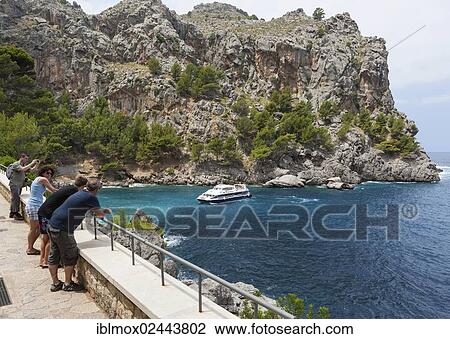 "Tourists watch the ferries in the Bay of La Calobra, Tramuntana Mountains, Majorca, Balearic Islands, Mediterranean Sea, Spain, Europe" View Large Photo Image Stock Image - "Tourists watch the ferries in the Bay of La Calobra, Tramuntana Mountains, Majorca, Balearic Islands, Mediterranean Sea, Spain, Europe". Fotosearch