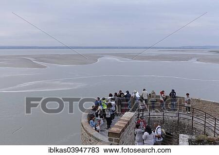 "Tourists watching the Wadden Sea at evening tide, view from the Mont Saint-Michel, Le Mont Saint-Michel, Departement Manche, Lower Normandy, France, Europe" View Large Photo Image Stock Image - "Tourists watching the Wadden Sea at evening tide, view from the Mont Saint-Michel, Le Mont Saint-Michel, Departement Manche, Lower Normandy, France, Europe". Fotosearch