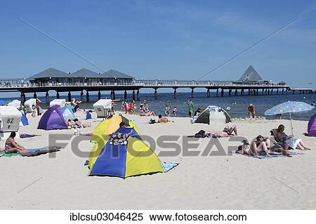 "Tourists with beach tents on the beach in front of the pier, Heringsdorf, Mecklenburg-Western Pomerania, Germany, Europe" View Large Photo Image Stock Photography - "Tourists with beach tents on the beach in front of the pier, Heringsdorf, Mecklenburg-Western Pomerania, Germany, Europe". Fotosearch