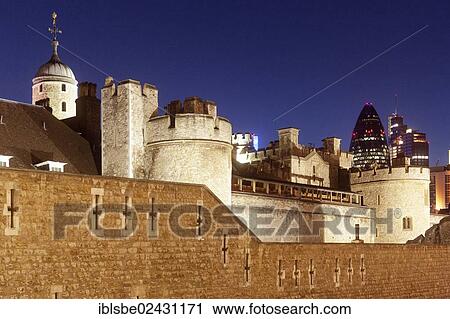 Stock Image - "Tower of London at dusk in front of the Swiss Re Tower, The Gherkin, London, England, United Kingdom, Europe". Fotosearch