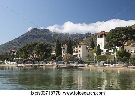 "Town view with beach and mountains, Port de Pollenca, Pollenca, Serra de Tramuntana, Majorca, Balearic Islands, Spain, Europe" View Large Photo Image Stock Photo - "Town view with beach and mountains, Port de Pollenca, Pollenca, Serra de Tramuntana, Majorca, Balearic Islands, Spain, Europe". Fotosearch