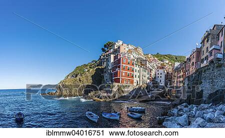 Stock Image - "Town view with harbor and colorful houses, Riomaggiore, Cinque Terre, La Spezia, Liguria, Italy, Europe". Fotosearch
