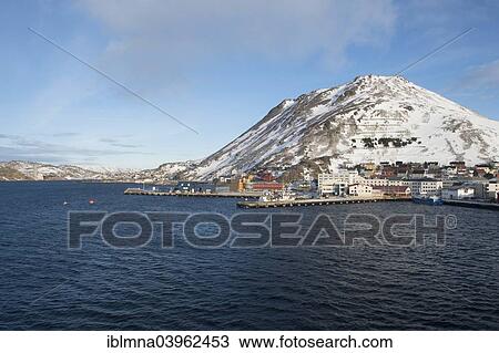 Stock Image - "Townscape with piers and snow-covered mountain, Honningsvag, Mageroya island, Finnmark County, Norway, Europe". Fotosearch