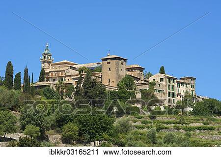 Stock Image - "Townscape with the Charterhouse or Royal Carthusian Monastery of Valldemossa, Valldemossa, Majorca, Balearic Islands, Spain, Europe". Fotosearch