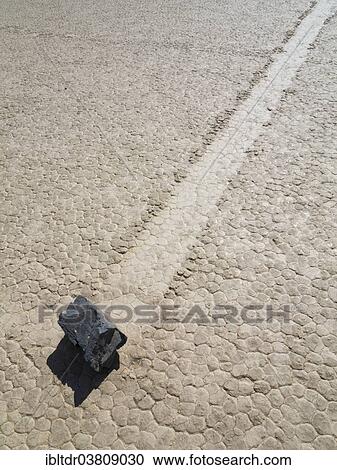 Stock Image - "Track created by one of the mysterious moving rocks at the """"Racetrack"""", a dry lakebed or playa, Death Valley, Death Valley National Park, California, USA". Fotosearch