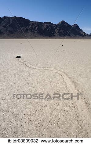 "Track created by one of the mysterious moving rocks at the """"Racetrack"""", a dry lakebed or playa, Death Valley, Death Valley National Park, California, USA" View Large Photo Image Stock Image - "Track created by one of the mysterious moving rocks at the """"Racetrack"""", a dry lakebed or playa, Death Valley, Death Valley National Park, California, USA". Fotosearch