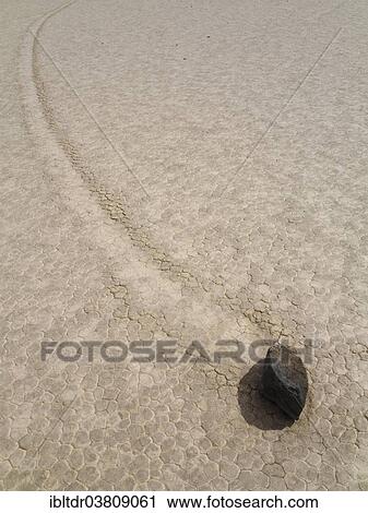 "Track created by one of the mysterious moving rocks at the """"Racetrack"""", a dry lakebed or playa, Death Valley, Death Valley National Park, California, USA" View Large Photo Image Stock Image - "Track created by one of the mysterious moving rocks at the """"Racetrack"""", a dry lakebed or playa, Death Valley, Death Valley National Park, California, USA". Fotosearch