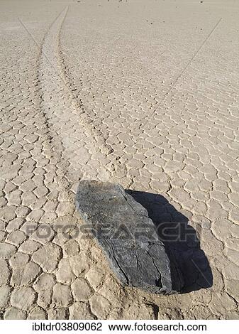 "Track created by one of the mysterious moving rocks at the """"Racetrack"""", a dry lakebed or playa, Death Valley, Death Valley National Park, California, USA" View Large Photo Image Stock Image - "Track created by one of the mysterious moving rocks at the """"Racetrack"""", a dry lakebed or playa, Death Valley, Death Valley National Park, California, USA". Fotosearch