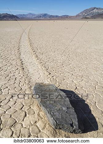 Stock Image - "Track created by one of the mysterious moving rocks at the """"Racetrack"""", a dry lakebed or playa, Death Valley, Death Valley National Park, California, USA". Fotosearch