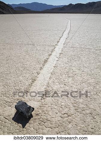 "Track created by one of the mysterious moving rocks at the """"Racetrack"""", a dry lakebed or playa, Death Valley, Death Valley National Park, California, USA" View Large Photo Image Stock Photo - "Track created by one of the mysterious moving rocks at the """"Racetrack"""", a dry lakebed or playa, Death Valley, Death Valley National Park, California, USA". Fotosearch