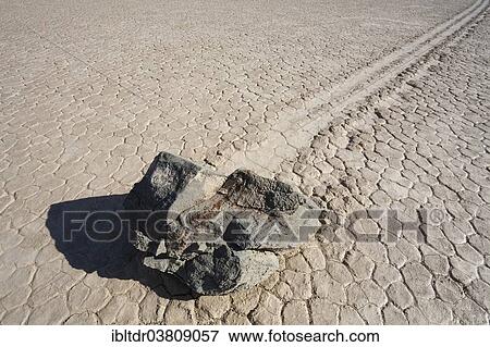 "Track created by one of the mysterious moving rocks at the """"Racetrack"""", a dry lakebed or playa, Death Valley, Death Valley National Park, California, USA" View Large Photo Image Stock Photo - "Track created by one of the mysterious moving rocks at the """"Racetrack"""", a dry lakebed or playa, Death Valley, Death Valley National Park, California, USA". Fotosearch