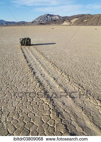 "Track created by one of the mysterious moving rocks at the """"Racetrack"""", a dry lakebed or playa, Death Valley, Death Valley National Park, California, USA" View Large Photo Image Stock Photo - "Track created by one of the mysterious moving rocks at the """"Racetrack"""", a dry lakebed or playa, Death Valley, Death Valley National Park, California, USA". Fotosearch