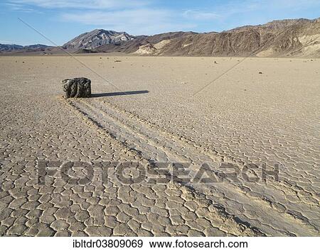 Stock Photo - "Track created by one of the mysterious moving rocks at the """"Racetrack"""", a dry lakebed or playa, Death Valley, Death Valley National Park, California, USA". Fotosearch