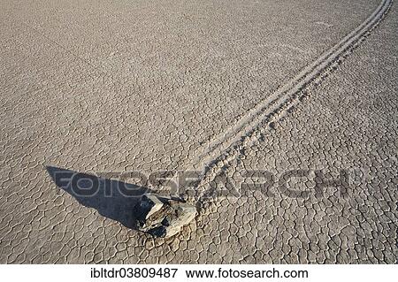 Stock Photo - "Track created by one of the mysterious moving rocks at the """"Racetrack"""", a dry lakebed or playa, Death Valley, Death Valley National Park, California, USA". Fotosearch