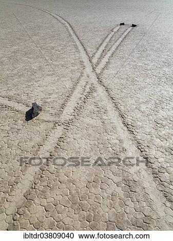 "Tracks created by the mysterious moving rocks at the """"Racetrack"""", a dry lakebed or playa, Death Valley, Death Valley National Park, California, USA" View Large Photo Image Stock Image - "Tracks created by the mysterious moving rocks at the """"Racetrack"""", a dry lakebed or playa, Death Valley, Death Valley National Park, California, USA". Fotosearch