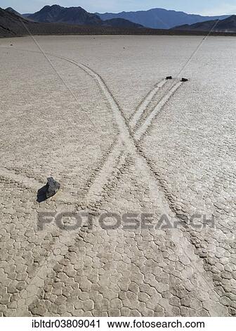 "Tracks created by the mysterious moving rocks at the """"Racetrack"""", a dry lakebed or playa, Death Valley, Death Valley National Park, California, USA" View Large Photo Image Stock Image - "Tracks created by the mysterious moving rocks at the """"Racetrack"""", a dry lakebed or playa, Death Valley, Death Valley National Park, California, USA". Fotosearch