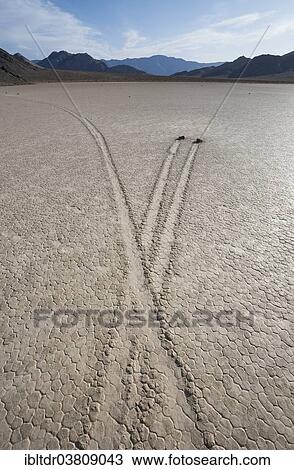 "Tracks created by the mysterious moving rocks at the """"Racetrack"""", a dry lakebed or playa, Death Valley, Death Valley National Park, California, USA" View Large Photo Image Stock Image - "Tracks created by the mysterious moving rocks at the """"Racetrack"""", a dry lakebed or playa, Death Valley, Death Valley National Park, California, USA". Fotosearch