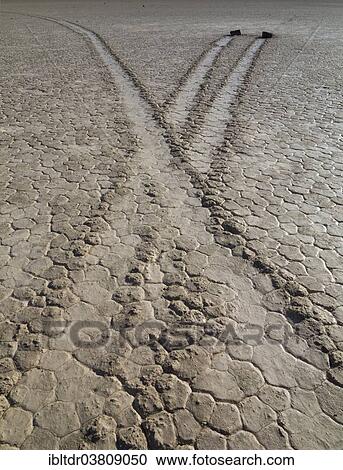 Stock Image - "Tracks created by the mysterious moving rocks at the """"Racetrack"""", a dry lakebed or playa, Death Valley, Death Valley National Park, California, USA". Fotosearch