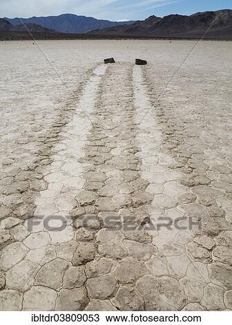 "Tracks created by the mysterious moving rocks at the """"Racetrack"""", a dry lakebed or playa, Death Valley, Death Valley National Park, California, USA" View Large Photo Image Stock Image - "Tracks created by the mysterious moving rocks at the """"Racetrack"""", a dry lakebed or playa, Death Valley, Death Valley National Park, California, USA". Fotosearch