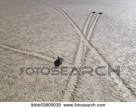 "Tracks created by the mysterious moving rocks at the """"Racetrack"""", a dry lakebed or playa, Death Valley, Death Valley National Park, California, USA" View Large Photo Image Stock Photo - "Tracks created by the mysterious moving rocks at the """"Racetrack"""", a dry lakebed or playa, Death Valley, Death Valley National Park, California, USA". Fotosearch