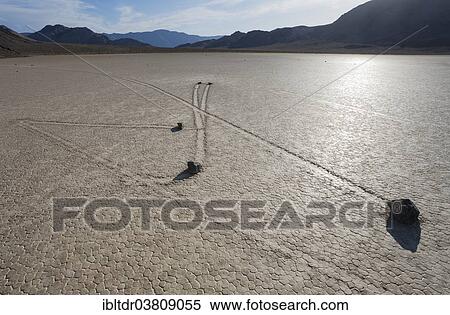 Stock Photography - "Tracks created by the mysterious moving rocks at the """"Racetrack"""", a dry lakebed or playa, Death Valley, Death Valley National Park, California, USA". Fotosearch
