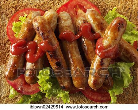 Traditional chipolatta pork sausages with tomato ketchup View Large Photo Image Picture - Traditional chipolatta pork sausages with tomato ketchup. Fotosearch