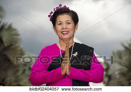 "Traditional dance, smiling woman wearing traditional clothing making a gesture of greeting or Wai, Loi Krathong or Loy Gratong Festival, Chiang Mai, Northern Thailand, Thailand, Asia" View Large Photo Image Stock Photo - "Traditional dance, smiling woman wearing traditional clothing making a gesture of greeting or Wai, Loi Krathong or Loy Gratong Festival, Chiang Mai, Northern Thailand, Thailand, Asia". Fotosearch