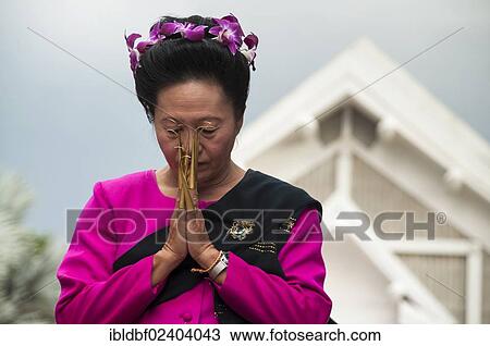 Stock Image - "Traditional dance, woman wearing traditional clothing making a gesture of greeting or Wai, Loi Krathong or Loy Gratong Festival, Chiang Mai, Northern Thailand, Thailand, Asia". Fotosearch