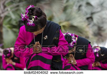 Stock Image - "Traditional dance, women wearing traditional clothing making a gesture of greeting or Wai, Loi Krathong or Loy Gratong Festival, Chiang Mai, Northern Thailand, Thailand, Asia". Fotosearch