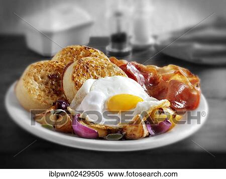 "Traditional English fried breakfast with crumpets, fried egg, fried potatoes and bacon" View Large Photo Image Stock Photography - "Traditional English fried breakfast with crumpets, fried egg, fried potatoes and bacon". Fotosearch