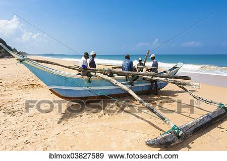 "Traditional fishermen with an outrigger boat on the beach, near Duwemodara Galle Region, Southern Province, Sri Lanka, Asia" View Large Photo Image Stock Photo - "Traditional fishermen with an outrigger boat on the beach, near Duwemodara Galle Region, Southern Province, Sri Lanka, Asia". Fotosearch