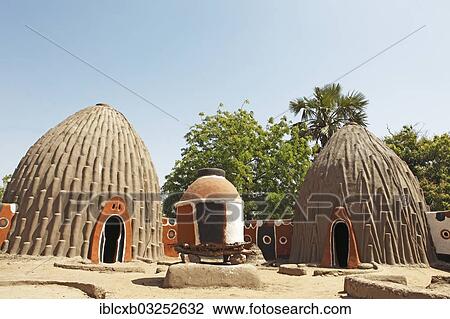 Stock Image - "Traditional houses of the Mousgoum fishermen with a granary, Pouss, Far North, Cameroon, Africa". Fotosearch