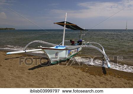 "Traditional outrigger boat on the black lava beach, Lovina Beach, North Bali, Bali, Indonesia, Asia" View Large Photo Image Stock Photo - "Traditional outrigger boat on the black lava beach, Lovina Beach, North Bali, Bali, Indonesia, Asia". Fotosearch