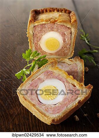 "Traditional pork pie with an egg in the middle, Melton Mowbray Pork Pie" View Large Photo Image Picture - "Traditional pork pie with an egg in the middle, Melton Mowbray Pork Pie". Fotosearch